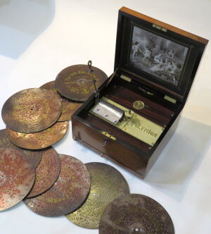 Disc musical box by Polyphon of Leipzig circa 1900. Walnut veneer to case, repolished and mechanism professionally serviced. Plays 9 1/2 inch /24 cm discs (10 included). Integral winding lever, key to lock.<br /><br />Sold with a 2 year guarantee .<br /><br />Case 12 x 11 x 7 1/8 inches<br /><br />&pound;2.650